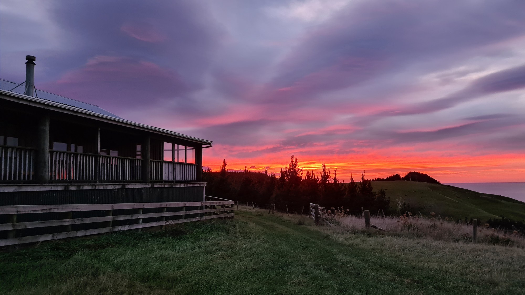 Sunrise beside Wai Ngaio Retreat above the coast